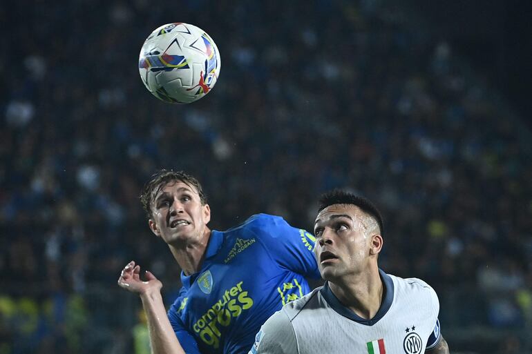 Inter Milan's Argentine forward #10 Lautaro Martinez (R) fights for the ball with Empoli's Norwegian midfielder #17 Ola Solbakken during the Italian Serie A football match Empoli vs Inter Milan at Carlo Castellani stadium in Empoli on October30, 2024. (Photo by Isabella BONOTTO / AFP)