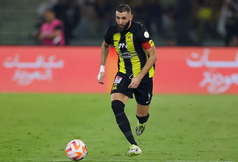 (FILES) Ittihad's French forward #09 Karim Benzema runs with the ball during the Saudi Pro League football match between Al-Ittihad and Al-Nassr at King Abdullah Sports City Stadium in Jeddah on December 26, 2023. Karim Benzema feels under "pressure" at his Saudi club Al-Ittihad and wants to leave "temporarily", a source close to the club told AFP on Tuesday. (Photo by AFP)