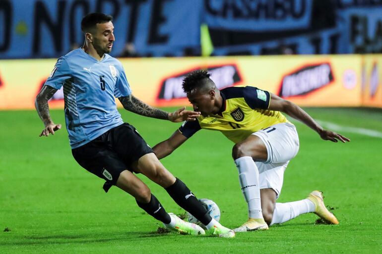 Matías Vecino (i), jugador de Uruguay, disputa el balón con Michael Estrada, futbolista de Ecuador, durante un partido por las Eliminatorias Sudamericanas para el Mundial Qatar 2022 en el estadio Campeón del Siglo, en Montevideo, Uruguay.