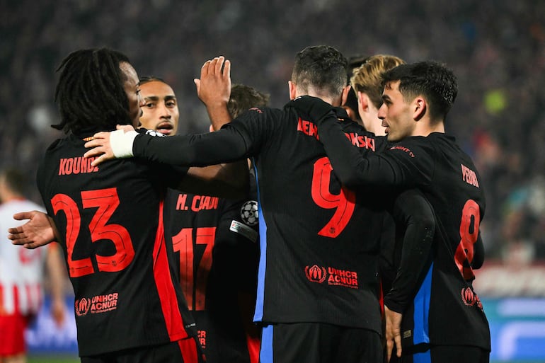 Barcelona's Polish forward #09 Robert Lewandowski (2R) celebrates with teammates after scoring a goal during the UEFA Champions League, League phase - Matchday 4 football match between Crvena Zvezda Beograd and FC Barcelona, at the Rajko-Mitic Stadium, in Belgrade, on November 6, 2024. (Photo by Andrej ISAKOVIC / AFP)