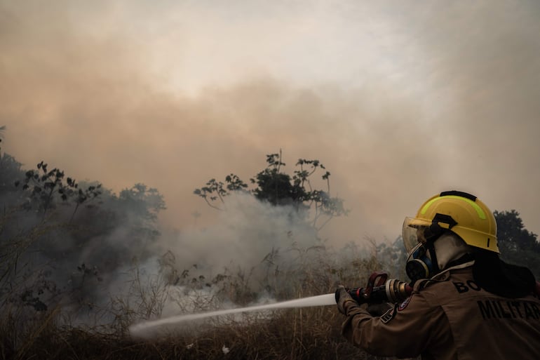 Un bombero trabaja para contener un incendio en una zona verde, en la ciudad de Manaos, Amazonas (Brasil). Amazonas, el estado más grande de Brasil, sufre una crisis ambiental. Luego de vivir la mayor sequía de su historia e incendios récord en 2023, todo indica que este año las cifras podrían ser superadas e incluso antes de lo previsto. 