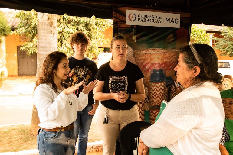 La viceministra de Agricultura del MAG, Ing. Rossana Ayala hablando con Luisa Fernandez de la Feria Ka´avo de San Juan Nepomuceno y la presidenta del Consejo de Desarrollo Departamental, Cheli Huttel.