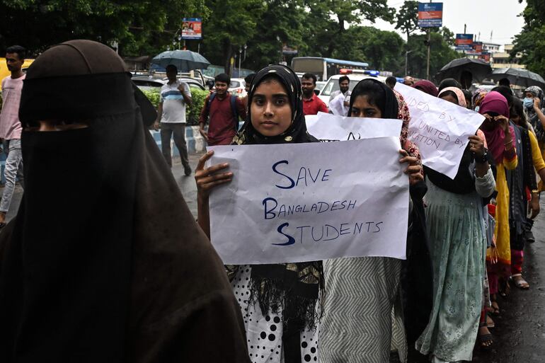 Estudiantes de la Universidad Aliah sostienen carteles mientras participan en una manifestación en Calcuta, Bangladesh.