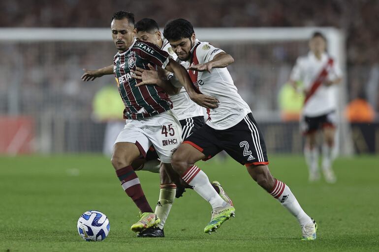 Robert Rojas (d) de River Plate disputa un balón con Lima de Fluminense en un partido de la fase de grupos de la Copa Libertadores entre River Plate y Fluminense en el estadio Mâs Monumental en Buenos Aires (Argentina).