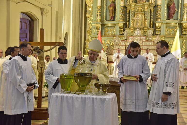 El cardenal Adalberto Martínez derrama perfume en uno de los óleos que serán utilizados en la consagración de los cristianos.