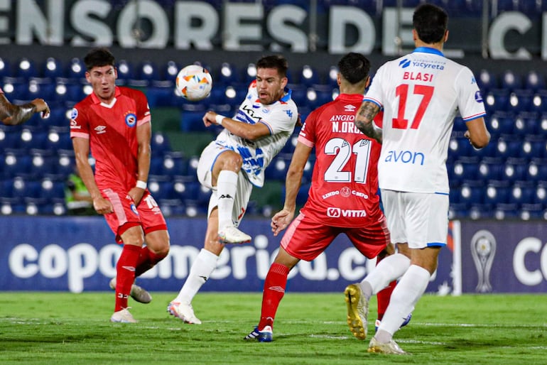 yo Edgardo Orzusa (7), futbolista de Nacional, pelea por el balón en un partido frente a Argentinos Juniors por la fase de grupos de la Copa Sudamericana 2024 en el estadio Defensores del Chaco, en Asunción.