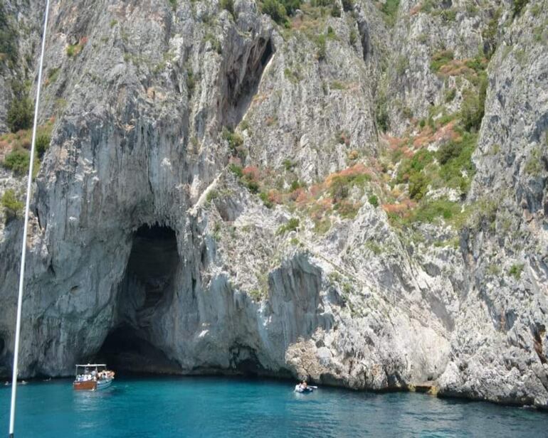 Botes de turistas llegando a la Gruta Azul en Capri, Italia.