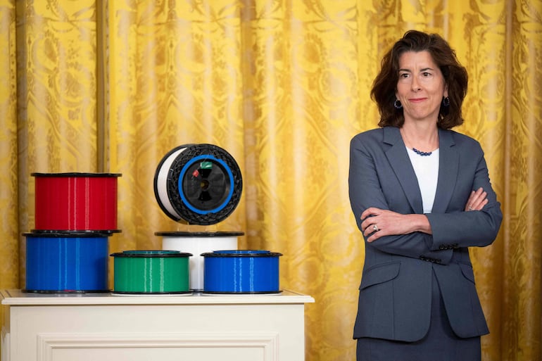 (FILES) US Secretary of Commerce Gina Raimondo looks on during a high-speed internet infrastructure announcement in the East Room of the White House in Washington, DC, on June 26, 2023. US Commerce Secretary Gina Raimondo said on July 25, 2023, she plans to visit China "later this summer," despite earlier reports that her email account was among those breached by China-based hackers. (Photo by Brendan Smialowski / AFP)