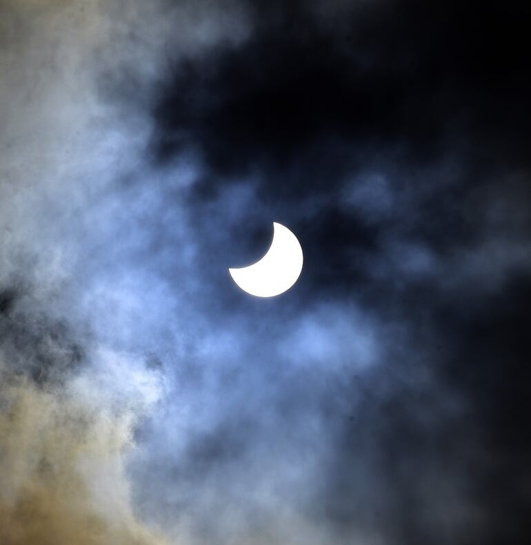 Eclipse de sol parcial, rodeado de nubes,  captado   desde el costado del Panteón de los Héroes de Asunción.