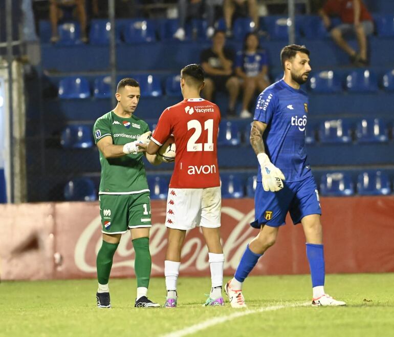 El saludo entre albos. Gustavo Aguilar al golero Héctor Espínola y el  “1”  aurinegro Rodríguez se aleja.