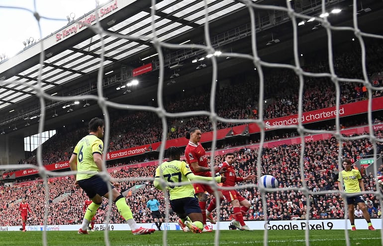 Liverpool's Uruguayan striker #09 Darwin Nunez scores the equalising goal during the English Premier League football match between Liverpool and Southampton at Anfield in Liverpool, north west England on March 8, 2025. (Photo by Paul ELLIS / AFP) / RESTRICTED TO EDITORIAL USE. No use with unauthorized audio, video, data, fixture lists, club/league logos or 'live' services. Online in-match use limited to 120 images. An additional 40 images may be used in extra time. No video emulation. Social media in-match use limited to 120 images. An additional 40 images may be used in extra time. No use in betting publications, games or single club/league/player publications. / 