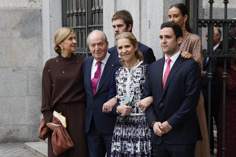 El rey emérito Juan Carlos I acompañado por sus hijas, las infantas Cristina (i) y Elena (2d) de Borbón, y sus nietos Felipe Juan Froilán de Marichalar (d), Victoria Federica de Marichalar (d, arriba) y Juan Valentín Urdangarín (c, detrás) posan a su salida de la boda del alcalde de Madrid, José Luis Martínez-Almeia, y Teresa Urquijo.