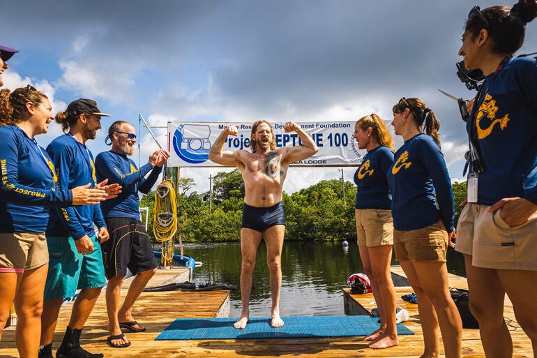 El explorador de buceo e investigador médico Joseph Dituri (c), conocido como "Dr. Deep Sea" (Doctor Mar Profundo), mientras celebra tras su salida del agua, en Cayo Largo, Florida (EEUU). Dituri emergió este viernes tras completar 100 días en un refugio submarino en los Cayos de Florida, en el sur de EE.UU., y haber batido en mayo el récord mundial de permanencia bajo el agua.