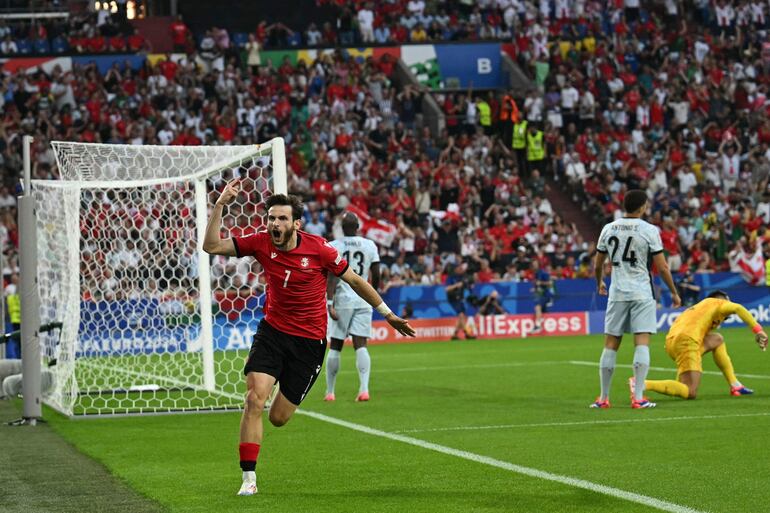 Georgia's forward #07 Khvicha Kvaratskhelia celebrates scoring his team's first goal during the UEFA Euro 2024 Group F football match between Georgia and Portugal at the Arena AufSchalke in Gelsenkirchen on June 26, 2024. (Photo by OZAN KOSE / AFP)