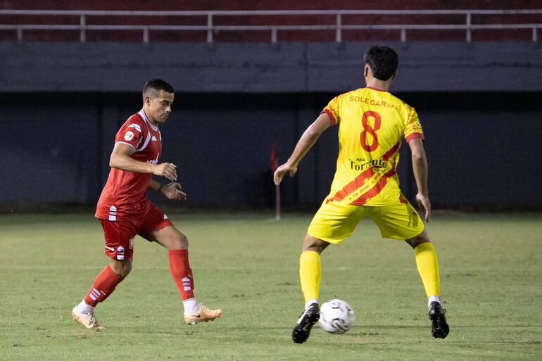 El volante del "3", Jorge "Torito" González intenta ejecutar el pase ante la presencia del aurirrojo Víctor Fernández. (Foto: APF)