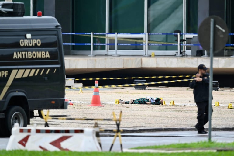 El cuerpo de Francisco Wanderley Luiz es custodiado por uniformados policiales. 