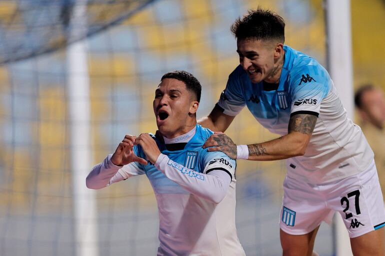 Racing's Colombian midfielder Juan Fernando Quintero (L) celebrates with teammate defender Gabriel Rojas after scoring his team's second goal during the Copa Sudamericana round of 16 first leg football match between Chile's Huachipato and Argentina's Racing at the Sausalito stadium in Viña del Mar, Chile, on August 13, 2024. (Photo by Javier TORRES / AFP)