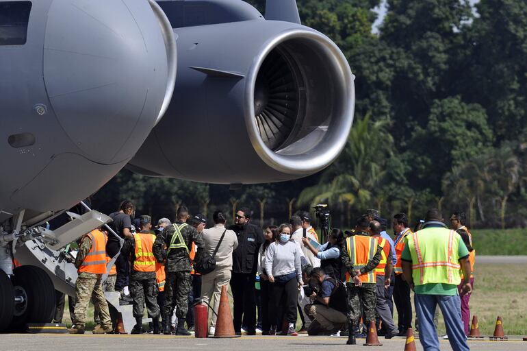 Personas deportadas llegan en un avión militar estadounidense, a la base aérea Armando Escalon ubicada en San Pedro Sula (Honduras). El primero de dos vuelos con migrantes hondureños deportados de EE.UU. en aviones militares llegó este viernes a La Lima, norte de Honduras, y fue recibido por autoridades del Gobierno que preside Xiomara Castro.