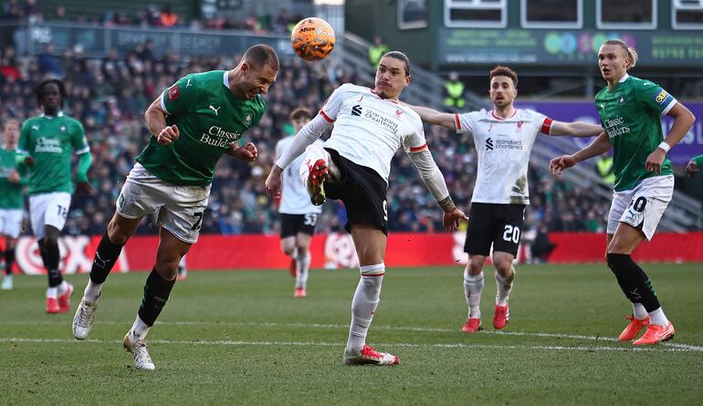 Plymouth's Bosnian defender #25 Nikola Katic (L) headers the ball away from Liverpool's Uruguayan striker #09 Darwin Nunez during the English FA Cup fourth round football match between Plymouth Argyle and Liverpool at Home Park in Plymouth, south west England, on February 9, 2025. (Photo by HENRY NICHOLLS / AFP) / RESTRICTED TO EDITORIAL USE. No use with unauthorized audio, video, data, fixture lists, club/league logos or 'live' services. Online in-match use limited to 120 images. An additional 40 images may be used in extra time. No video emulation. Social media in-match use limited to 120 images. An additional 40 images may be used in extra time. No use in betting publications, games or single club/league/player publications. / 