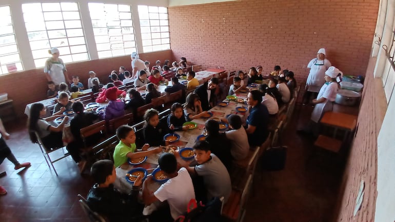 Niños de la Escuela Básica Calle 10 de RI 3 Corrales, recibiendo sus almuerzo en una sala de clases clausurada.