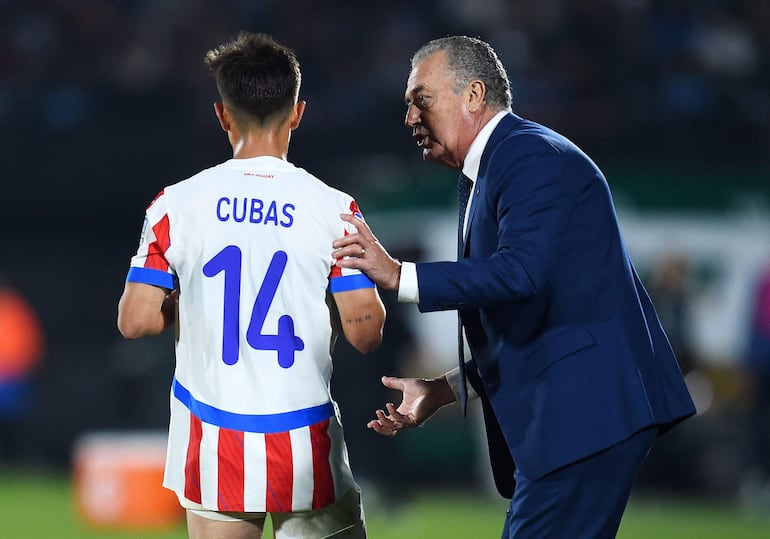 Andrés Cubas (i) y Gustavo Alfaro, jugador y entrenador de la selección de Paraguay, conversan durante el partido frente a Uruguay por la séptima fecha de las Eliminatorias Sudamericanas 2026 en el estadio Centenario, en Montevideo, Uruguay.