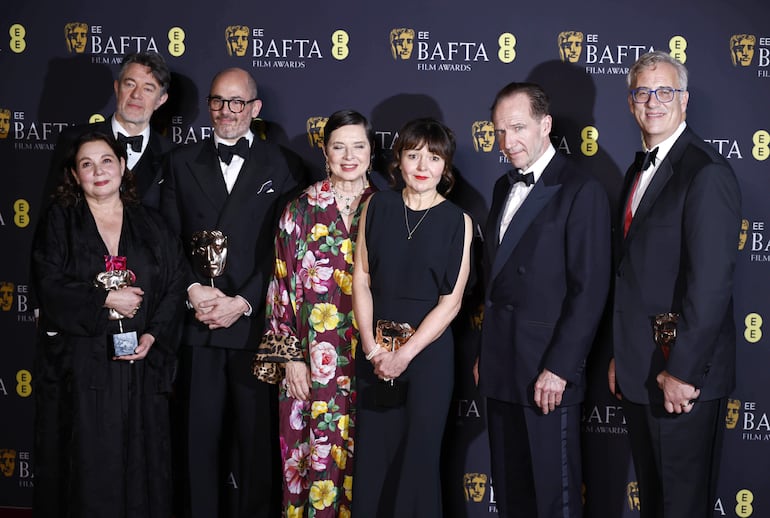 Tessa Ross, Peter Straughan, Edward Berger, Isabella Rossellini, Juliette Howell, Ralph Fiennes y Michael Jackman posan en la sala de prensa con el premio a la mejor película por 'Conclave' durante los premios BAFTA de cine en el Royal Festival Hall de Londres, Gran Bretaña, el 16 de febrero de 2025. La ceremonia está organizada por la Academia Británica de Cine y Televisión (BAFTA).