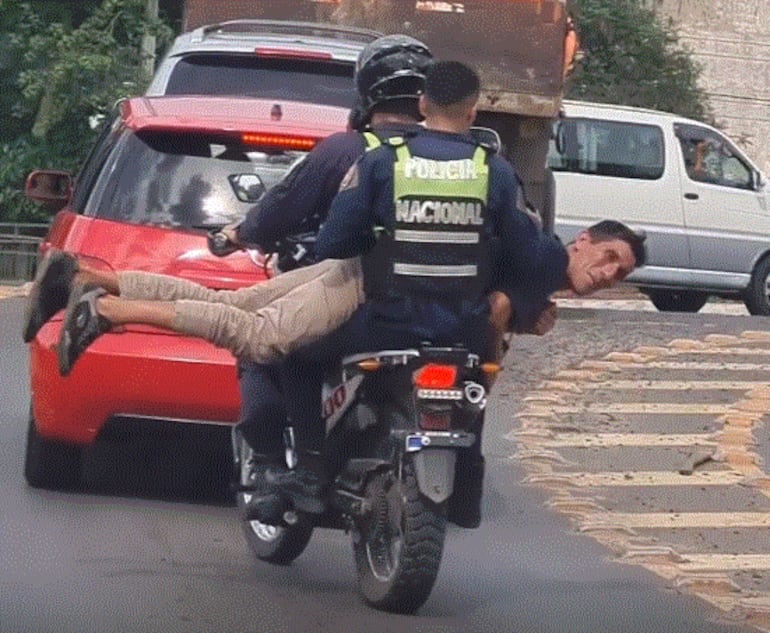 Agentes de la Policía Nacional trasladan a un aprehendido de manera peculiar.