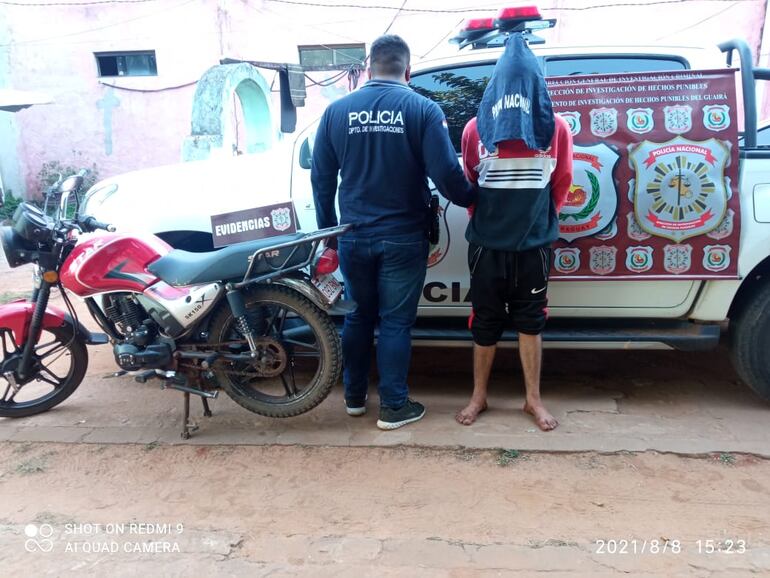 El aprehendido Dalvert Alexander Sánchez Sánchez (22) junto a la motocicleta recuperada.