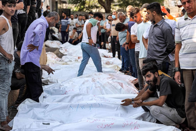 Cuerpos de víctimas de bombardeos israelíes fuera de la morgue dle hospital Shifa de la ciudad de Gaza, este jueves.