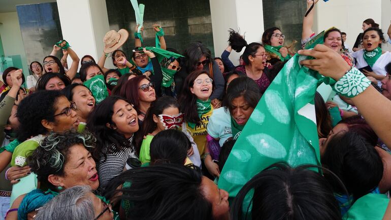 Feministas de la llamada "Marea Verde" celebran y ondean pañuelos luego de que el Congreso del estado de Oaxaca despenalizara este miércoles el aborto al aprobar un dictamen que autoriza la interrupción legal del embarazo antes de las 12 semanas de gestación, en Oaxaca (México).