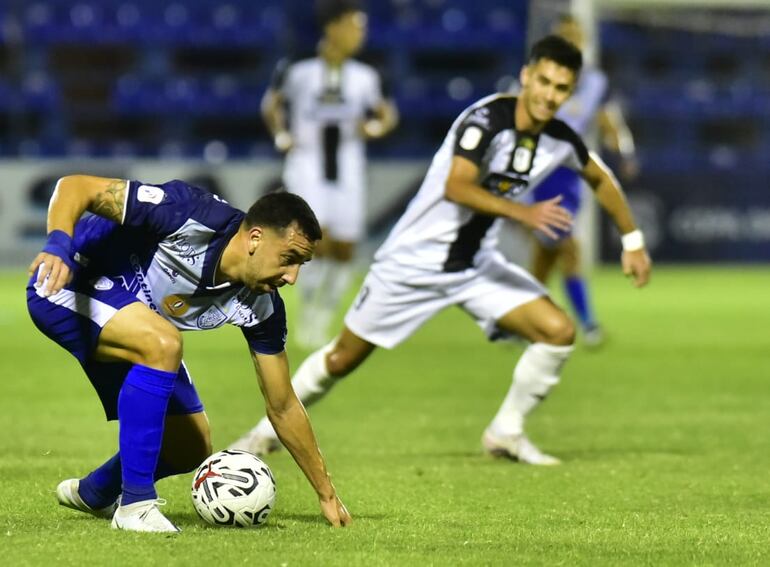 Abel Paredes, futbolista del Sportivo Ameliano, protege el balón en un partido frente a Tacuary por el fútbol paraguayo en el estadio Luis Alfonso Giagni, en Villa, Paraguay.