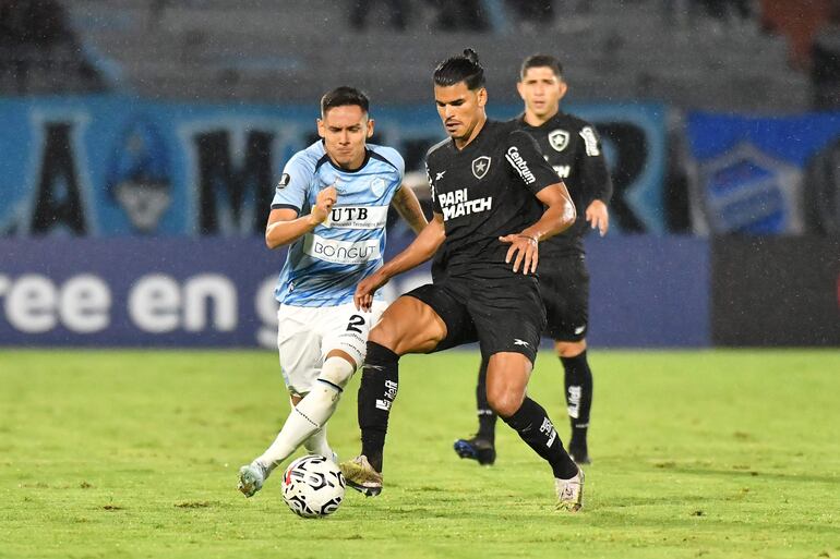 Mauricio Cabral (i) de Aurora disputa el balón con Danilo Barbosa de Botafogo este miércoles, en un partido de la segunda fase de la Copa Libertadores entre Aurora y Botafogo en el estadio Félix Capriles en Cochabamba (Bolivia).