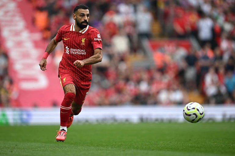 Liverpool's Egyptian striker #11 Mohamed Salah runs with the ball during the English Premier League football match between Liverpool and Bournemouth at Anfield in Liverpool, northwest England, on September 21, 2024. (Photo by Paul ELLIS / AFP) / RESTRICTED TO EDITORIAL USE. No use with unauthorized audio, video, data, fixture lists, club/league logos or 'live' services. Online in-match use limited to 120 images. An additional 40 images may be used in extra time. No video emulation. Social media in-match use limited to 120 images. An additional 40 images may be used in extra time. No use in betting publications, games or single club/league/player publications. / 