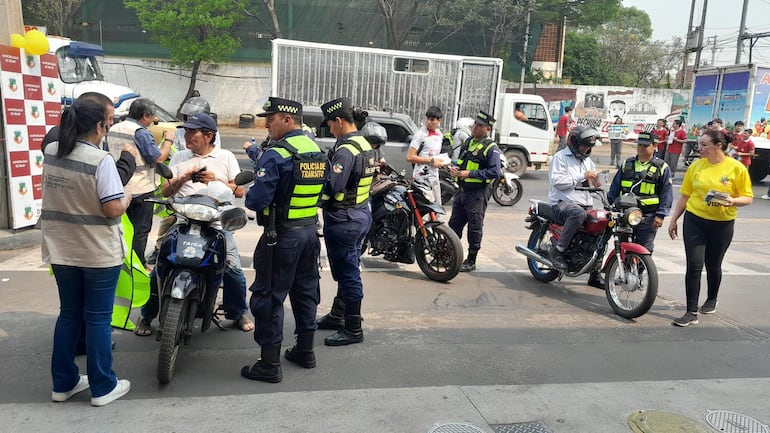 En Ñemby realizan jornada de concienciación por inicio de semana de seguridad vial. Entregan chalecos reflectivos y cascos a motociclistas con documentos al día.