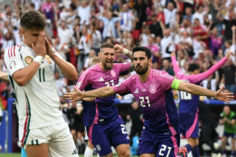 TOPSHOT - Germany's midfielder #21 Ilkay Gundogan celebrates scoring his team's second goal during the UEFA Euro 2024 Group A football match between Germany and Hungary at the Stuttgart Arena in Stuttgart on June 19, 2024. (Photo by THOMAS KIENZLE / AFP)