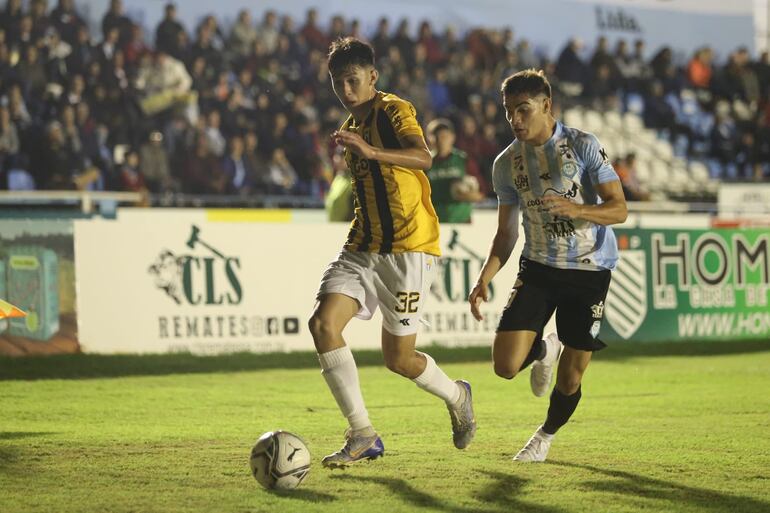 Alexis Cantero, de Guaraní, disputa el balón con Marcelo Acosta, de Guaireña, en el Parque del Guairá.