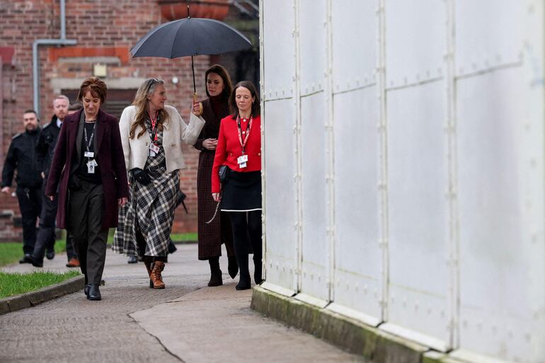 Britain's Catherine Princess of Wales (2R) speaks with staff during a visit to a mother and baby unit at Styal prison near Wilmslow, north-west England on February 11, 2025. (Photo by Phil Noble / POOL / AFP)