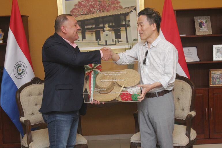 El gobernador de Ñeembucú  Víctor Hugo Fornerón, entrega un presente al embajador de Corea del Sur Chan- Sik Yoon. El regalo consiste en un trabajo de artesanía de Jatai, declarado patrimonio inmaterial del Paraguay.