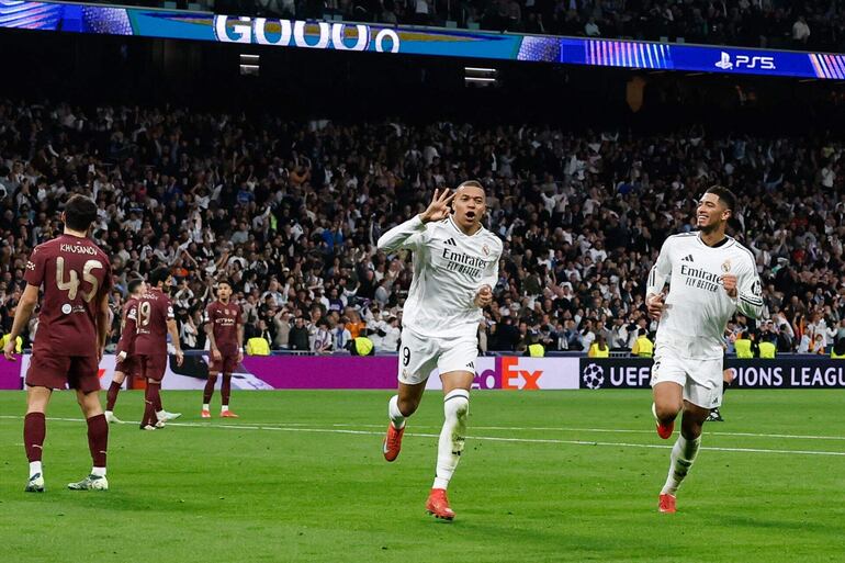 Real Madrid's French forward #09 Kylian Mbappe (C) celebrates scoring his third goal for a hat trick during the UEFA Champions League knockout phase play-off football match between Real Madrid CF and Manchester City at the Santiago Bernabeu stadium in Madrid on February 19, 2025. (Photo by OSCAR DEL POZO / AFP)