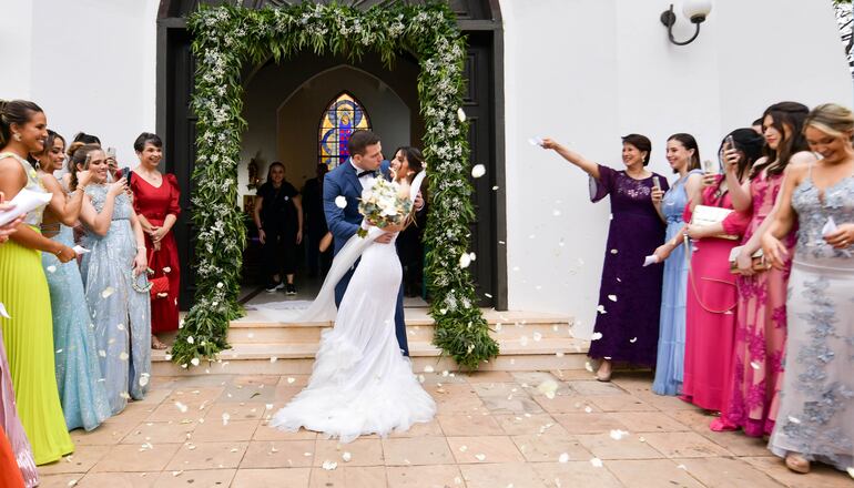 Patricia y Javier a la salida de la capilla recibieron los saludos con un lluvia de pétalos de rosa de sus amigas y familiares.