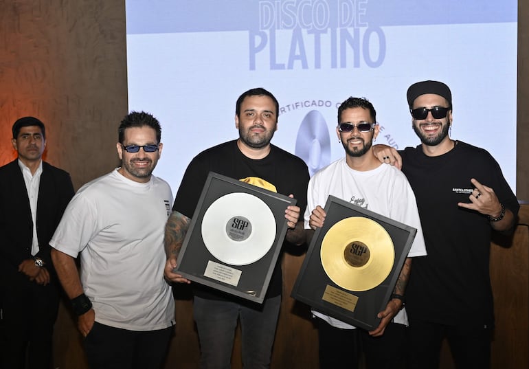 Los integrantes de Los Verduleros posan por los discos de Oro y Platino obtenidos por las reproducciones de sus canciones en las plataformas de streaming.