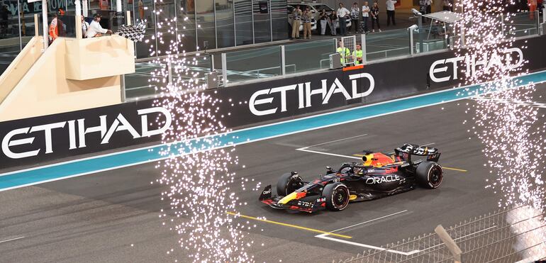 El Red Bull Racing de Max Verstappen cruza la meta con la bandera a cuadros del triunfo en el Gran Premio de Abu Dabi, la última carrera de la temporada 2023 de la Fórmula 1 en el Circuito Yas Marina.
