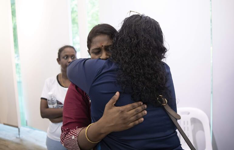 Leela (C), hermana de Tangaraju Suppiah, es abrazada luego de una conferencia de prensa en Singapore.