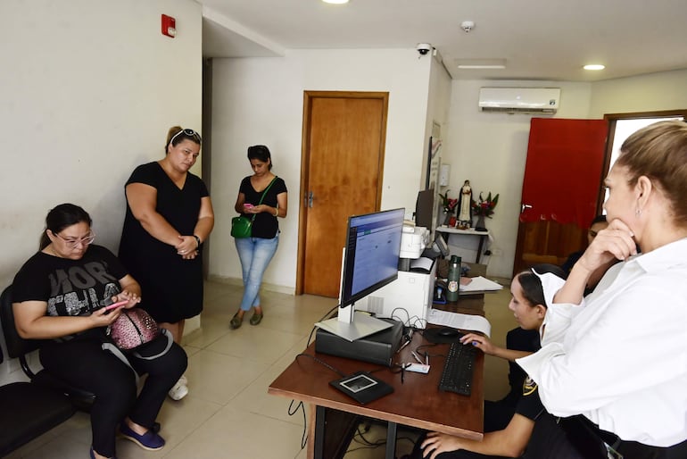 La directora de la escuela Carlos A. López, Lourdes Villalba, sentada y acompañada de dos profesoras en la Comisaría 12 de Trinidad, espera su turno para hacer la cuarta denuncia de robo en menos de una semana.