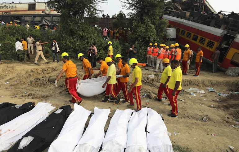 Los cuerpos de las víctimas fatales del accidente de trenes se apilan en 
 las cercanías de la estación donde se produjo el trágico suceso.  (EFE)