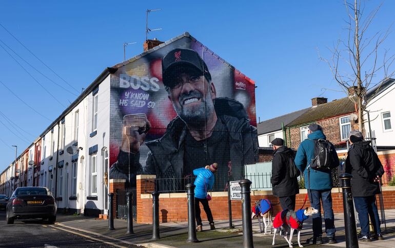 La gente toma fotografías de un mural del director del Liverpool, Jurgen Klopp, en Liverpool, Gran Bretaña, el 26 de enero de 2024. Klopp anunció el 26 de enero de 2024 que dejará el Liverpool FC al final de la temporada. Tras unirse al club en 2015, durante su etapa como entrenador el Liverpool ganó seis trofeos importantes, incluidas la Premier League y la UEFA Champions League. (Liga de Campeones, Reino Unido) EFE/EPA/ADAM VAUGHAN