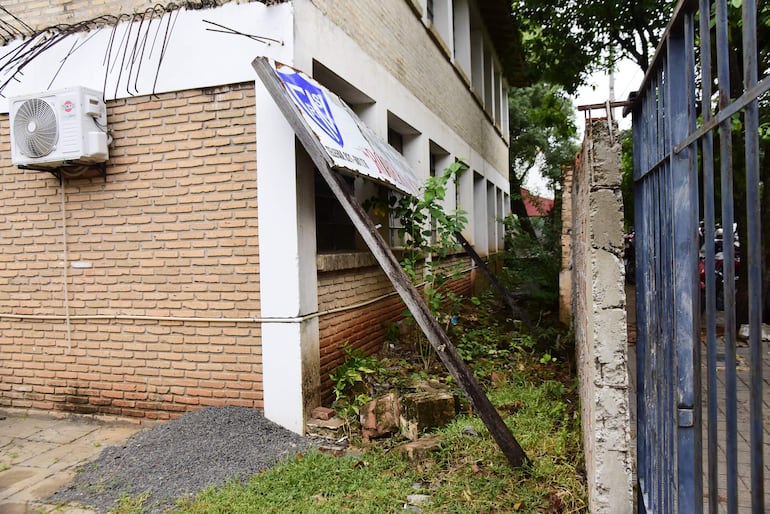 El cartel de la escuela Roberto Schaerer quedó apoyado por la pared de una de los salones, tras caída de la muralla en el 2020.