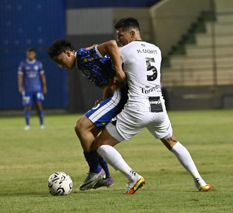 David Fernández y Marcos Cáceres pelean por el balón en Barrio Obrero