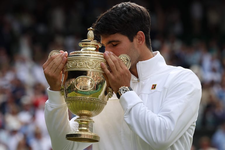 El tenista español Carlos Alcaraz celebra la victoria sobre Novak Djokovic y la conquista de Wimbledon en el All England Lawn Tennis and Croquet Club, en Wimbledon, Londres.