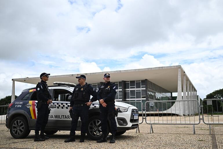 Integrantes de la Policía brasileña haciendo guardia en la sede de la Corte Suprema, en Brasilia (Brasil). La Policía Federal brasileña lanzó este martes una operación para desmantelar un esquema de lavado de dinero de la facción criminal Primer Comando de la Capital (PCC), la mafia más poderosa de Brasil, a través de empresas financieras digitales. EFE/Andre Borges ARCHIVO
